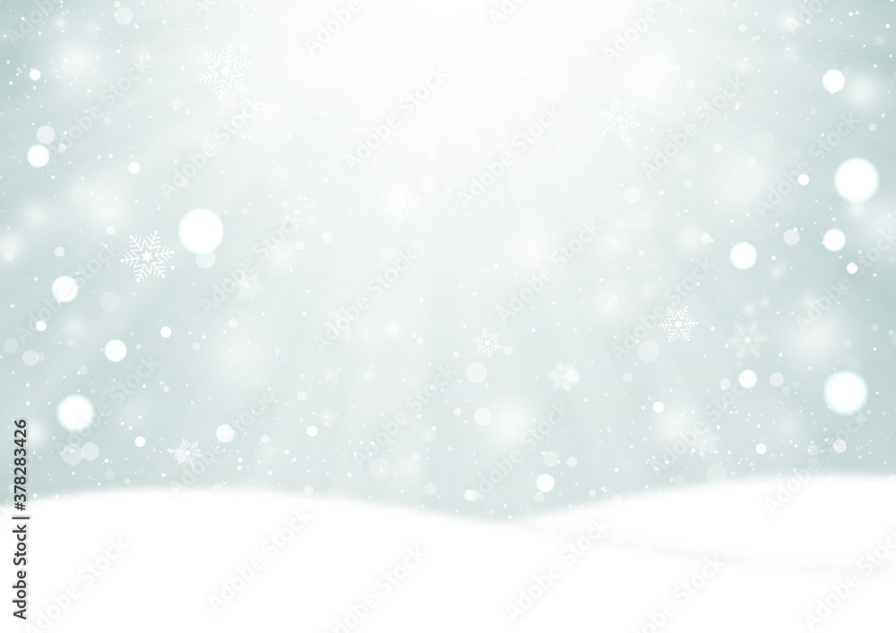 光芒と雪の結晶とふわふわの雪が降る雪原の風景　背景素材（銀色）