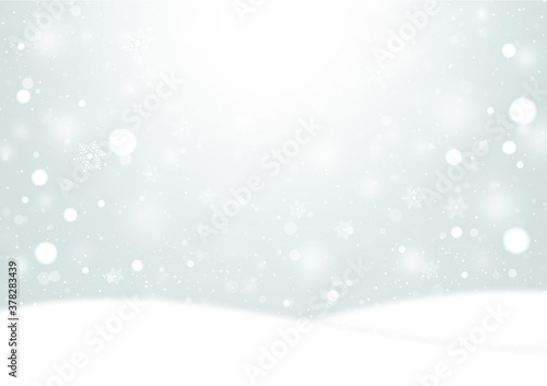  雪の結晶とふわふわの雪が降る雪原の風景　背景素材（銀色）