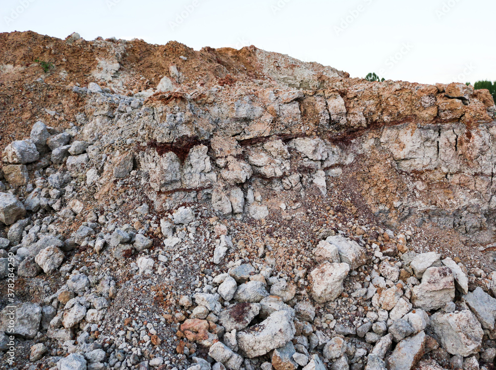 textures of various clay layers underground in clay quarry after geological study of soil. colored layers of clay and stone in section of earth, different rock formations and soil layers. textures of various clay layers underground in clay quarry after geological study of soil. colored layers of clay and stone in section of earth, different rock formations and soil layers.