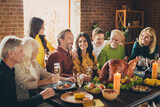 Portrait of full family eight members thanks giving blessing meeting sit table greeting dinner turkey table living room indoors