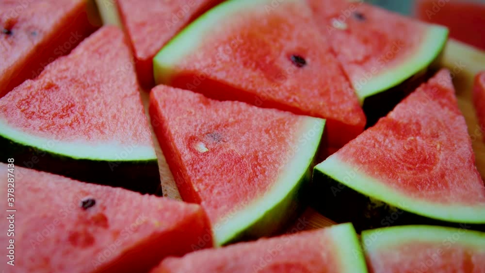 Rotation of fresh watermelon slices on cutting board. Close up shot 4K Rotation of fresh watermelon slices on cutting board. Close up shot 4K