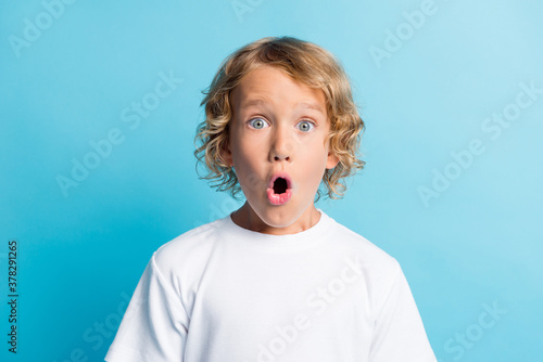 Portrait of boy feel astonished open mouth wear casual style clothes isolated over blue color background
