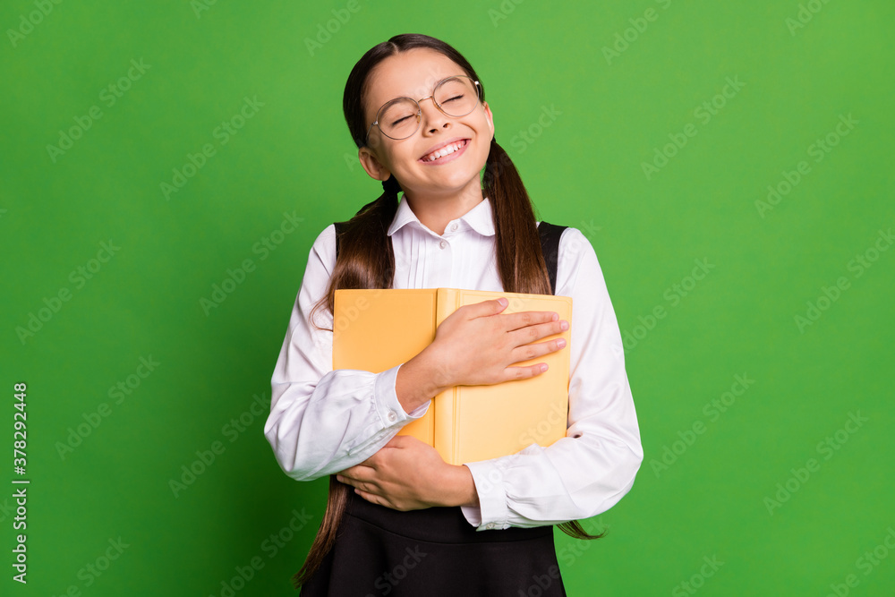 Photo of pretty cute small lady in front of blackboard embrace class book close eyes imagine favorite novel characters alive wear white shirt glasses isolated green color background Photo of pretty cute small lady in front of blackboard embrace class book close eyes imagine favorite novel characters alive wear white shirt glasses isolated green color background