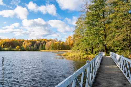 Wooden bridge and view of Mustion Linna park in autumn, Finland