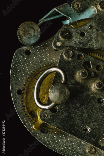 Close-up of old alarm clock mechanism on black background