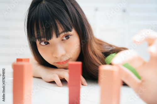 Fotografie Young asian woman selecting lipstick on table.