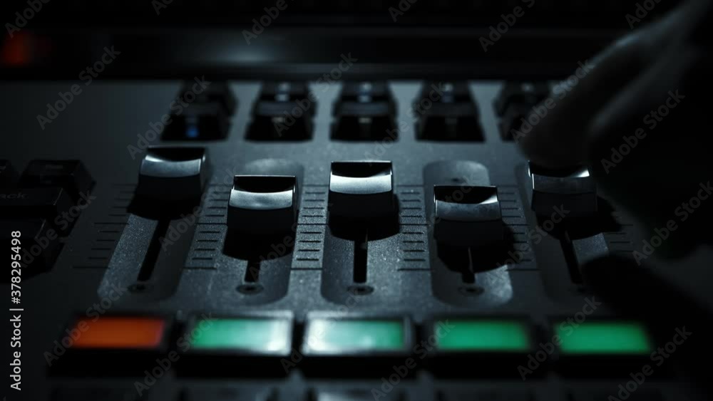 The Sound Engineer is adjusting the volume of the sound. Professional audio mixing console The Sound Engineer is adjusting the volume of the sound. Professional audio mixing console