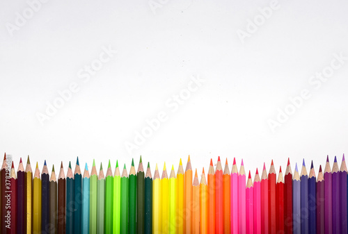 Many Color pencils isolated on white background close up. Color pencils for drawing as a background
