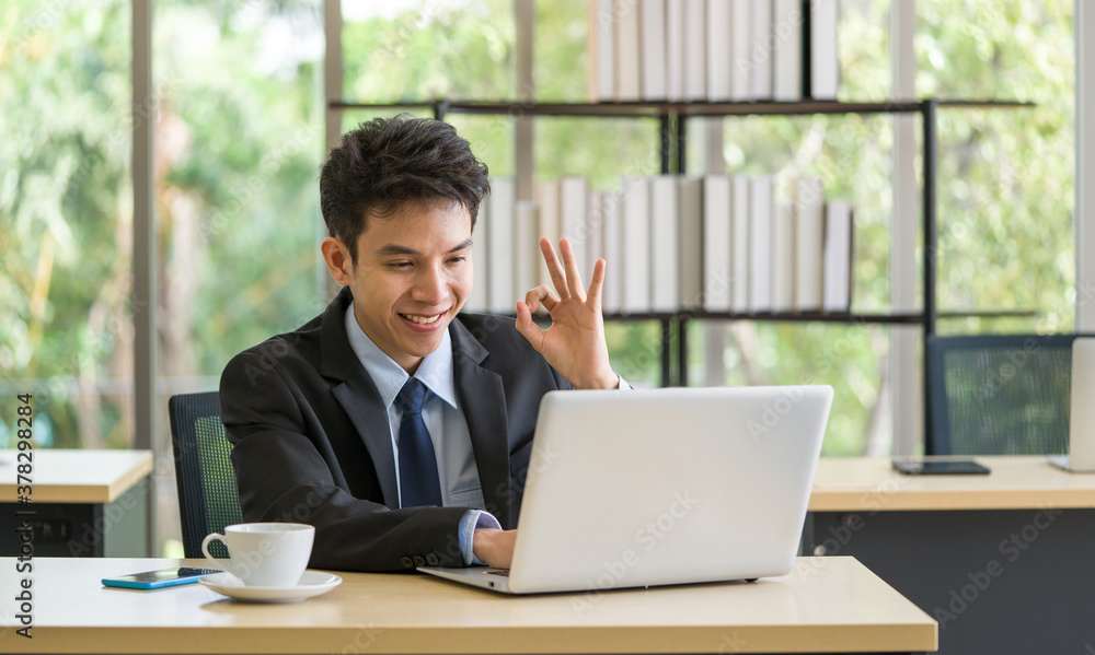 Asian businessman meeting with colleague online via video call using laptop computer in the office. Asian businessman meeting with colleague online via video call using laptop computer in the office.