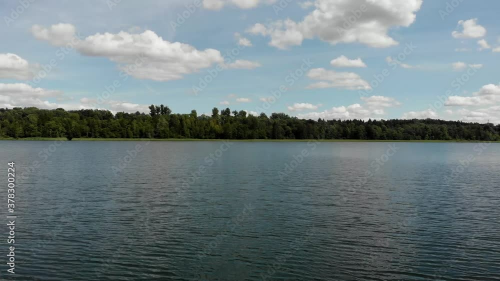 Drone Flying Across a Large Lake During the Middle of the Day Drone Flying Across a Large Lake During the Middle of the Day