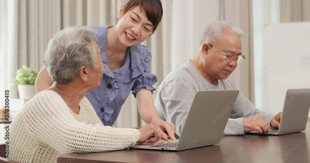 Daughter teaching mother and father using computer at home. Lifestyle and Technology concept. Daughter teaching mother and father using computer at home. Lifestyle and Technology concept.