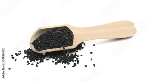 Black cumin, caraway seeds with wooden spoon isolated on white background