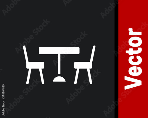 White Picnic table with chairs on either side of the table icon isolated on black background. Vector.