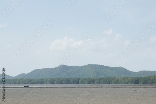 Green mountain with blue sky landscape.