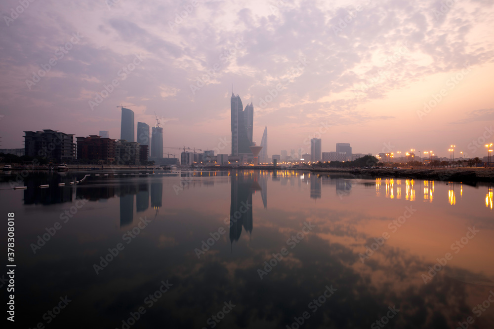 Bahrain skyline and beautiful hues on the sky and reflection on water during sunrise