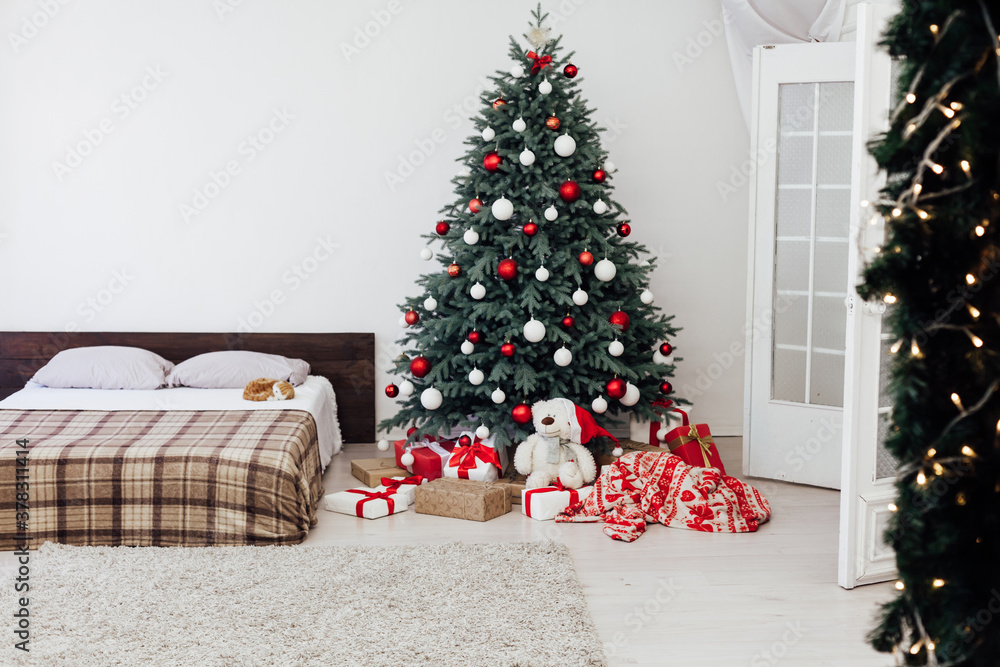 Blue Christmas tree in the bedroom with bed decor pine for the new year with gift card