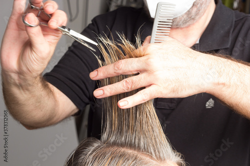 Professional hairdresser cutting a woman's hair
