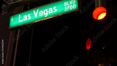 Fabulos Las Vegas, traffic sign glowing on The Strip in sin city of USA. Iconic signboard on the road to Fremont street in Nevada. Illuminated symbol of casino money playing and bets in gaming area. photo