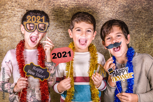 Three kids celebrating New Years Eve. 2021!