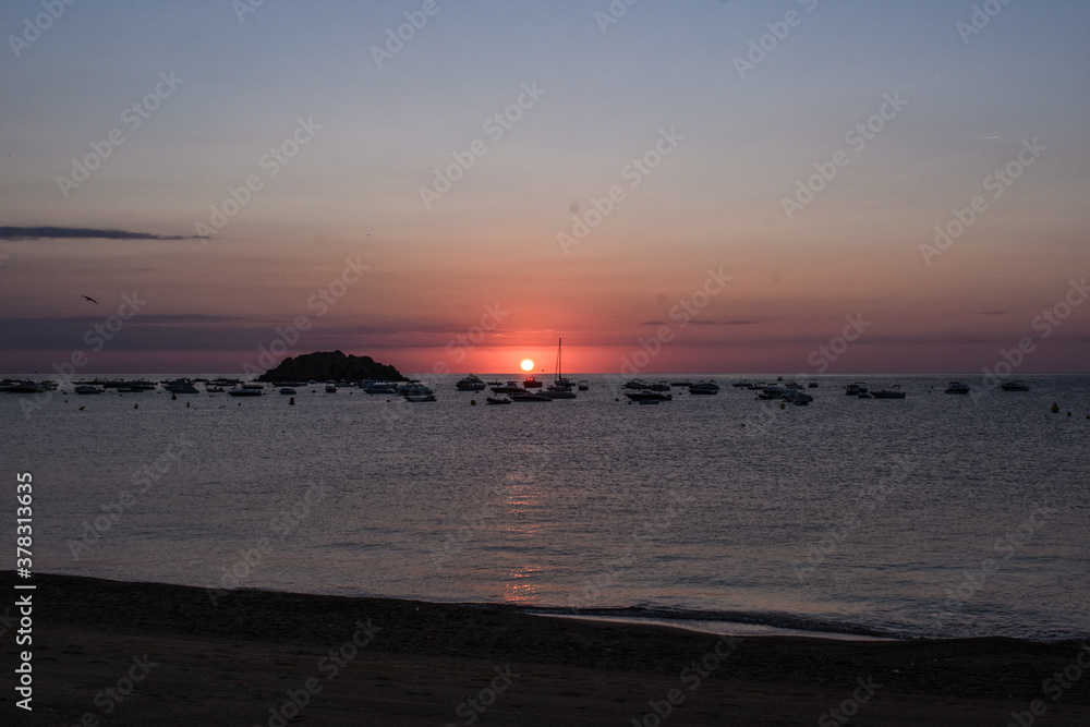 Sunrise on the beach of Tossa de Mar in the early hours of the day.