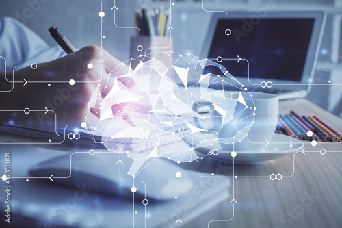 Multi exposure of writing hand on background with brain hologram. Concept of self learning.