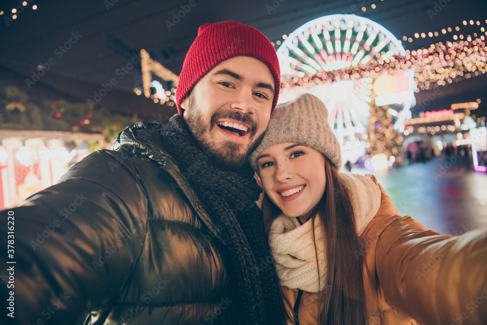 Photo of affectionate couple make selfie on x-mas christmas season town event wear winter coats hats scarf Photo of affectionate couple make selfie on x-mas christmas season town event wear winter coats hats scarf