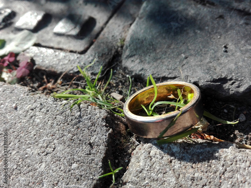 Wedding ring on the street in front of a manhole or drain