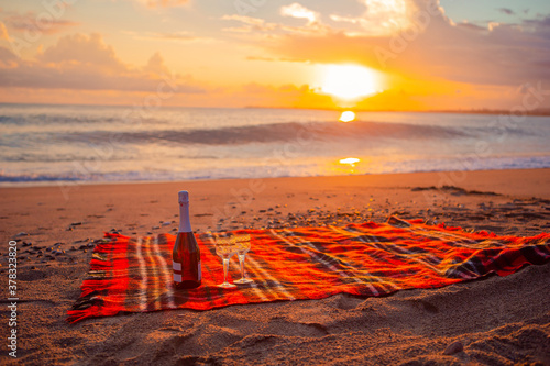 Fototapeta Naklejka Na Ścianę i Meble -  Having a picnic on the beach at sunset