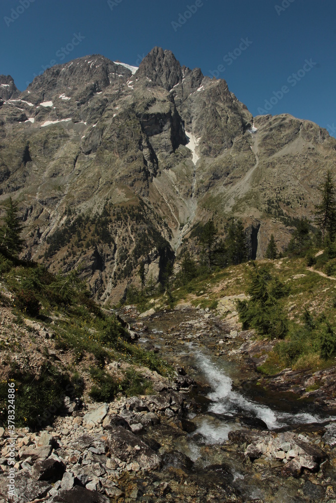 Beautiful view on mountain in Parc National des Ecrins, France at stream of nearby summersnow