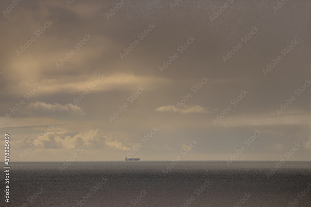 Sunrise over the sea with a boat on the horizon. Sunrise over the sea with a boat on the horizon.