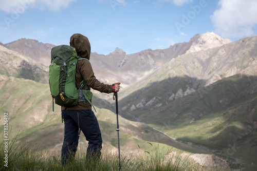 Backpacker hiking on high altitude mountain top