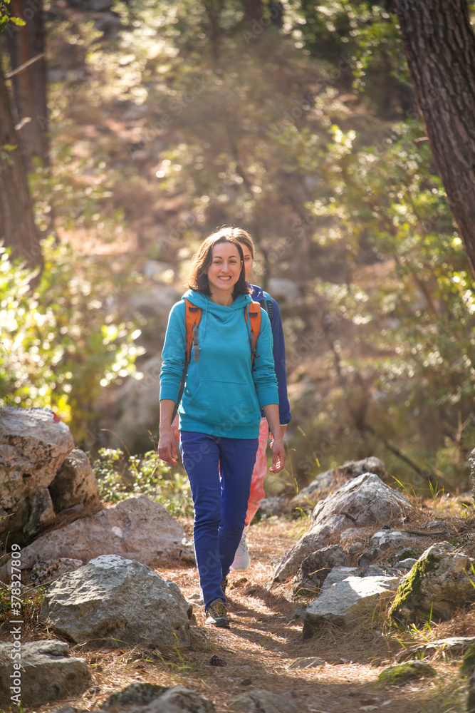 Two girls walk in the woods. Two girls walk in the woods.