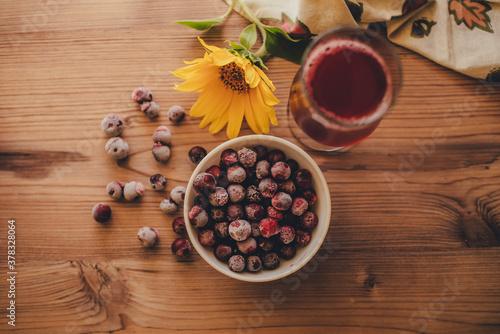 Fototapeta Naklejka Na Ścianę i Meble -  Still life. Frozen cherries and cherry juice on wooden background