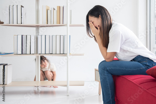 Fotografie Young Asian mother and daughter start to play hide and seek in the house, family