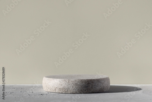 Monochrome gray template for mockup, banner. Flat round granite pedestal on textured background. Stone stand for natural design concept. Horizontal image, center composition, hard light, front view