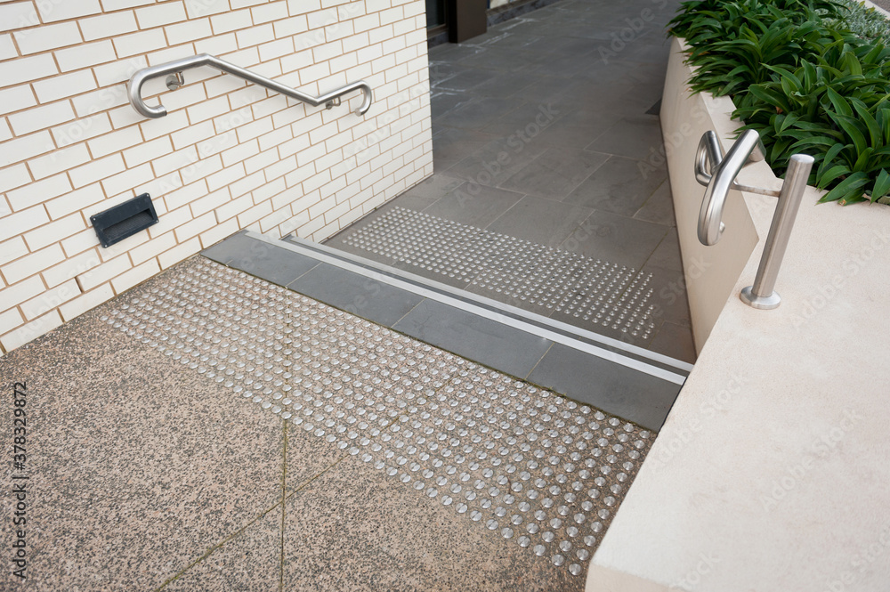 Details of railing and stairs of a modern building. Sidewalk guides for blind. Details of railing and stairs of a modern building. Sidewalk guides for blind.
