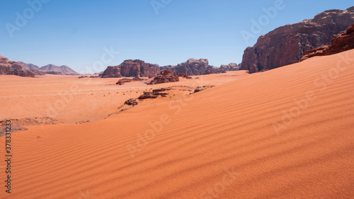sand dune in the background of cliffs in the Wadi Rum Desert Jordan. Hot Sandy landscape.