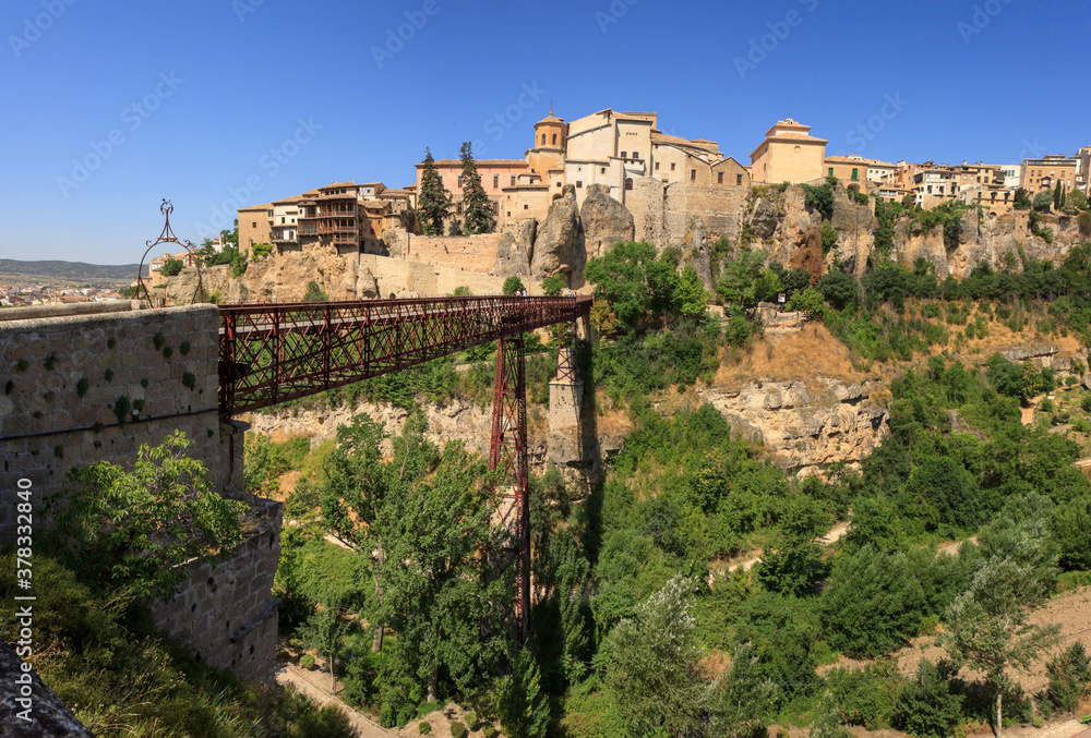 Old town of Cuenca, Spain, seen from the other side of the canyon (hoz) of the Huécar river near the iron San Pedro pedstrian bridge. To the left the famous hanging houses (cases colgadas).