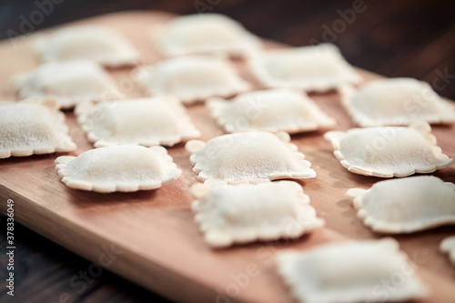 raw dumplings on teh wooden board