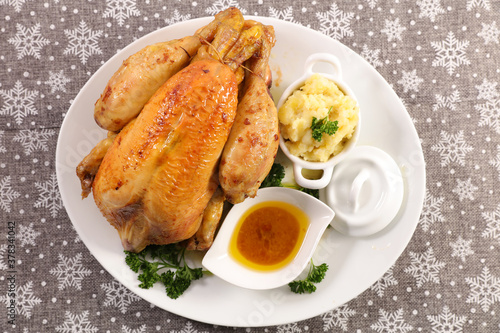 whole roasted chicken with mashed potato and sauce