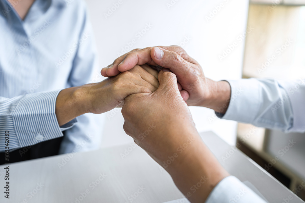 Doctor touching patient hand for encouragement and empathy on the hospital, cheering and support patient