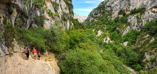 Hikers in the Verdon canyon, walking along the deep lying Verdon river on the famous Martel hiking trail, France photo