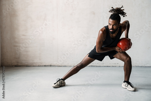 Image of african american sportsman working out with medicine ball © Drobot Dean