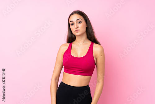 Young sport girl over isolated pink background happy and smiling © luismolinero