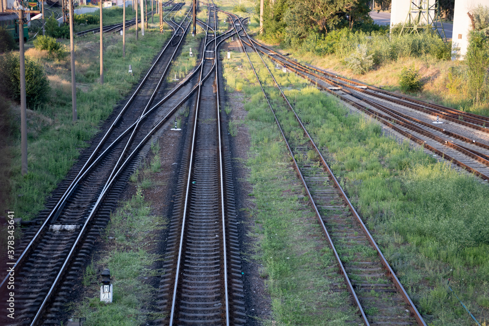 Summer railway tracks overgrown with green grass. Way out. Summer railway tracks overgrown with green grass. Way out.