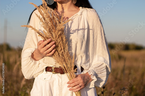 Girl in a field with spikelets