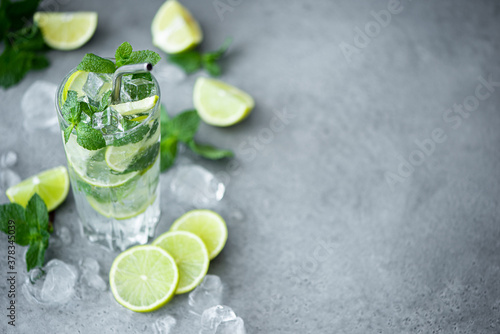 mojito cocktail with mint, lime and ice in a tall glass