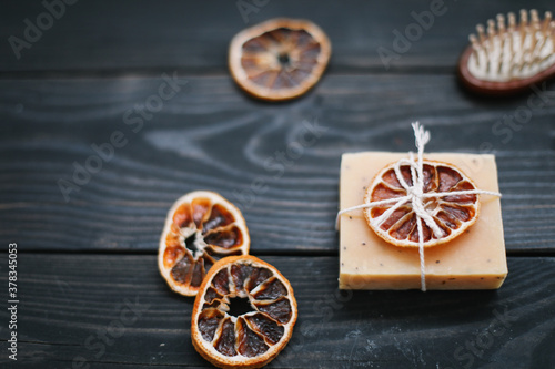 Natural citrus soap on dark background. Concept of Spa, Salon or Home body and skin care. Flat lay. Space for text, top view