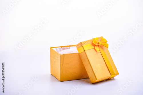 A open yellow gift box with bow ribbon on the white background, birthday, Christmas, Valentine day concept.