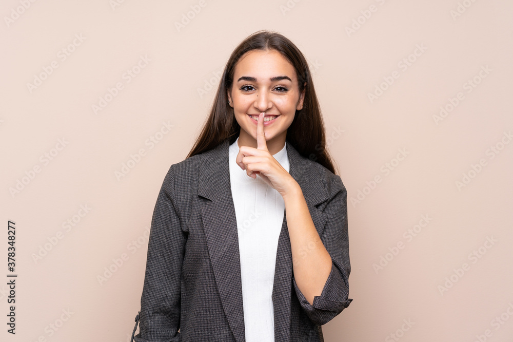 Young girl over isolated background doing silence gesture Young girl over isolated background doing silence gesture